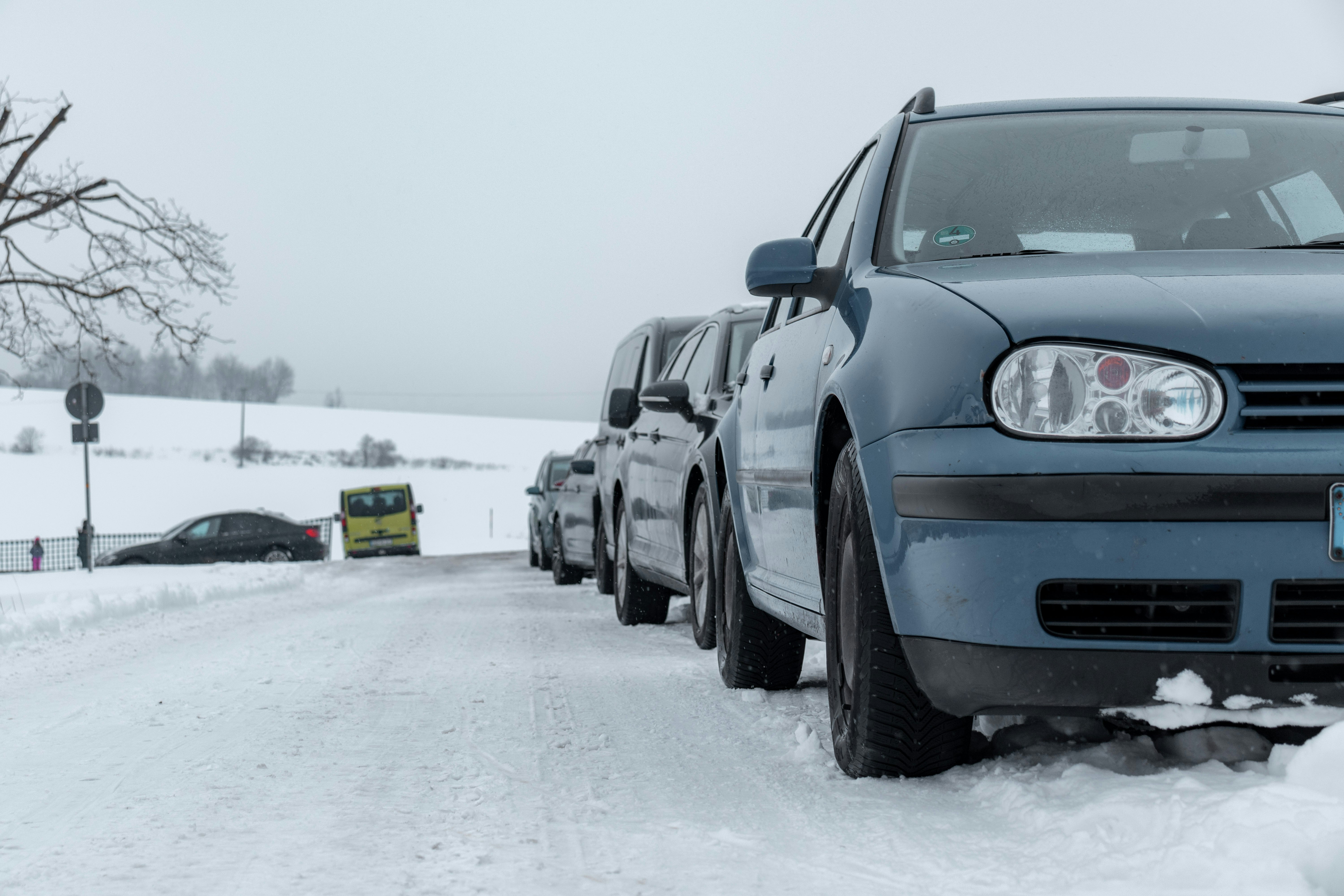 black car on snow covered ground during daytime